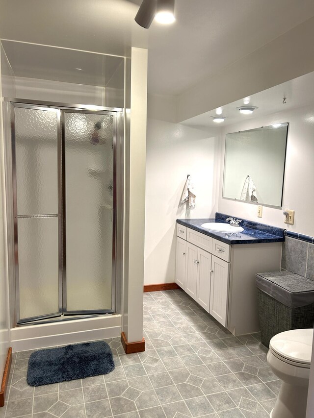 5392 Silver Beach Rd, Onaway, MI 49765 - full bath with a stall shower, vanity, toilet, and baseboards