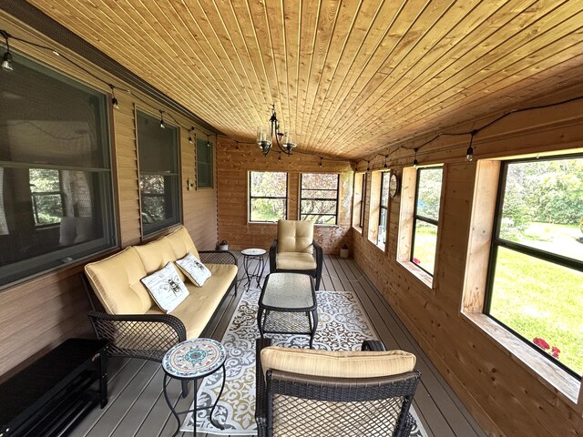 5392 Silver Beach Rd, Onaway, MI 49765 - sunroom with an outdoor living space, lofted ceiling, and a chandelier