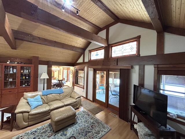 5392 Silver Beach Rd, Onaway, MI 49765 - living area with light wood-style flooring, wood ceiling with exposed beams, healthy amount of natural light, and high vaulted ceiling
