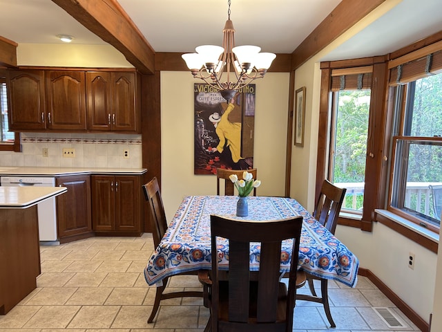 5392 Silver Beach Rd, Onaway, MI 49765 - dining room with a chandelier, baseboards, and light stone finish floors