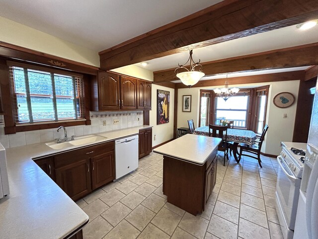 5392 Silver Beach Rd, Onaway, MI 49765 - kitchen with white appliances, a sink, backsplash, a chandelier, and light countertops