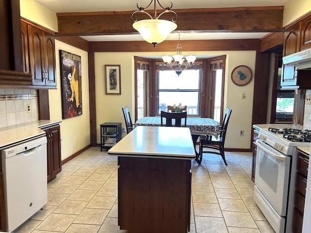 5392 Silver Beach Rd, Onaway, MI 49765 - kitchen with white appliances, healthy amount of natural light, decorative backsplash, beam ceiling, and a kitchen island