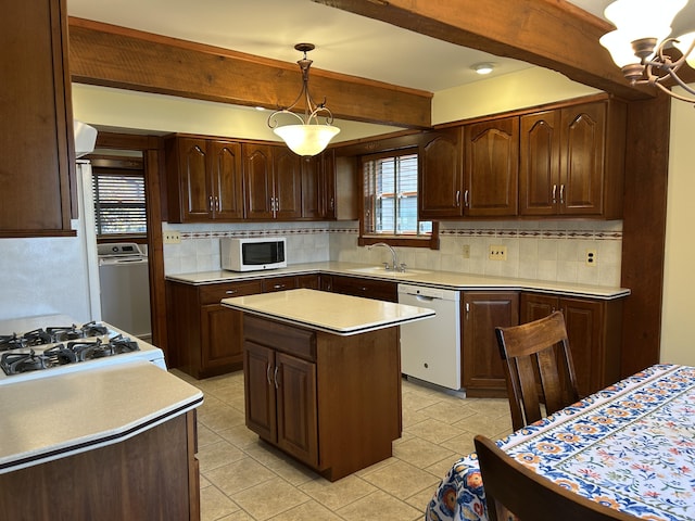 5392 Silver Beach Rd, Onaway, MI 49765 - kitchen featuring white appliances, beam ceiling, a sink, tasteful backsplash, and light countertops