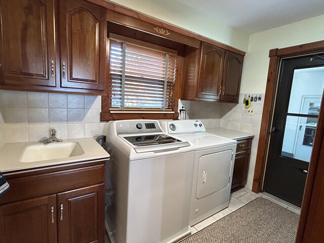 5392 Silver Beach Rd, Onaway, MI 49765 - washroom with cabinet space, washing machine and clothes dryer, and light tile patterned flooring