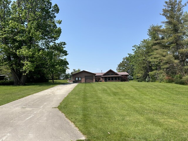 5392 Silver Beach Rd, Onaway, MI 49765 - ranch-style home with driveway and a front lawn
