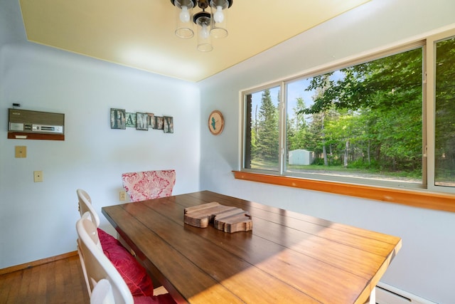 9150 W M-68, Indian River, MI 49749 - dining space with a baseboard heating unit, hardwood / wood-style flooring, and a chandelier