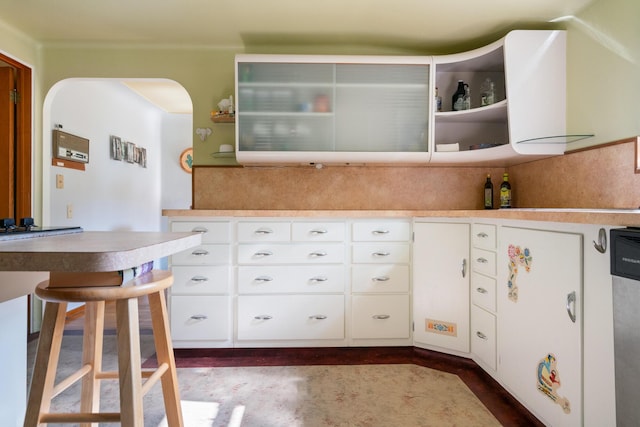 9150 W M-68, Indian River, MI 49749 - kitchen featuring light countertops, white cabinetry, open shelves, and arched walkways