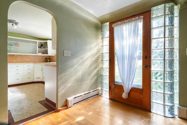 9150 W M-68, Indian River, MI 49749 - foyer featuring a baseboard radiator, arched walkways, and light wood-style floors