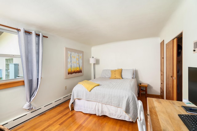 9150 W M-68, Indian River, MI 49749 - bedroom with a baseboard heating unit and wood finished floors