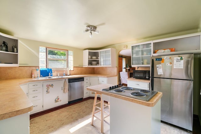 9150 W M-68, Indian River, MI 49749 - kitchen featuring open shelves, stainless steel appliances, white cabinetry, and light countertops