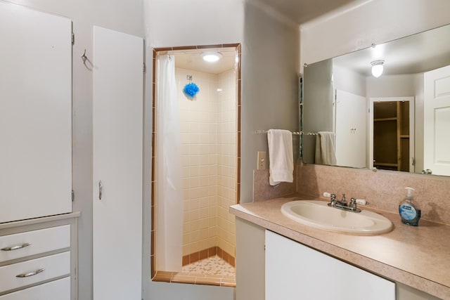 9150 W M-68, Indian River, MI 49749 - bathroom with vanity, tiled shower, and decorative backsplash
