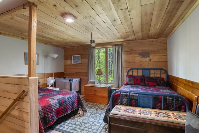3221 Krause Rd, Petoskey, MI 49770 - bedroom with wood walls, wooden ceiling, and wainscoting