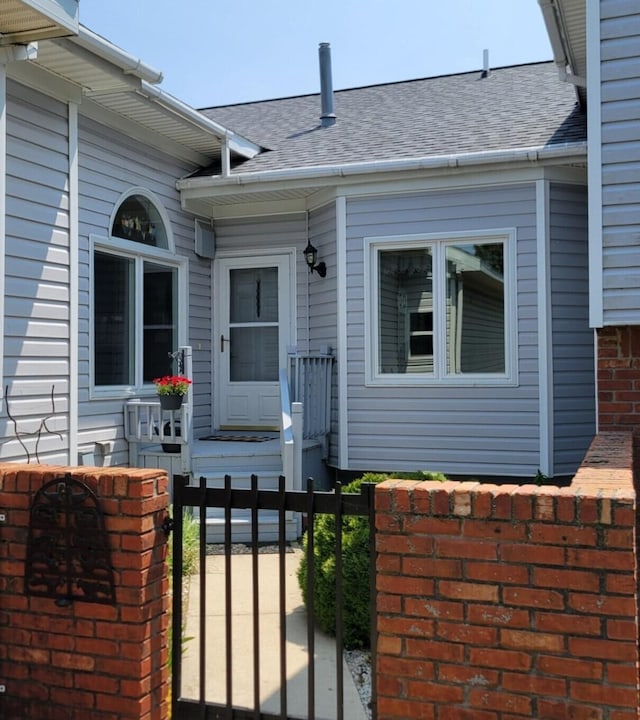 166 Long Rapids Rd, Alpena, MI 49707 - property entrance featuring a shingled roof and a gate