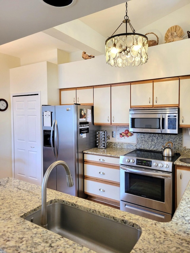 166 Long Rapids Rd, Alpena, MI 49707 - kitchen with appliances with stainless steel finishes, backsplash, a sink, and light stone countertops