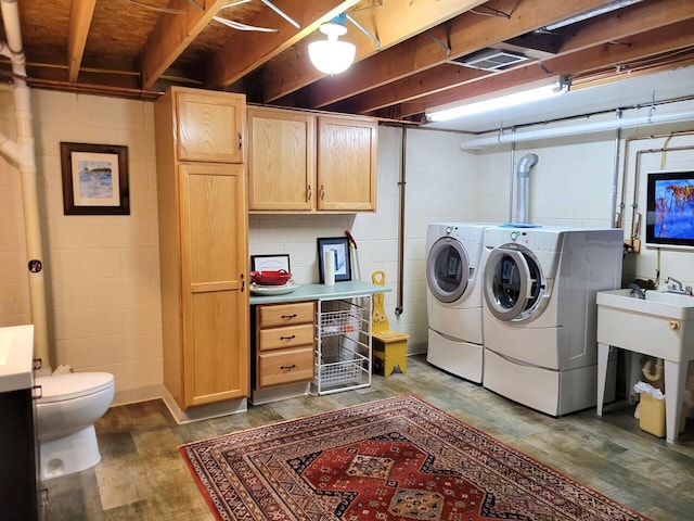 166 Long Rapids Rd, Alpena, MI 49707 - laundry area with washer and clothes dryer, wood finished floors, and concrete block wall