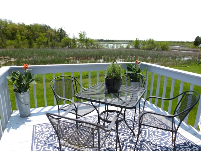 166 Long Rapids Rd, Alpena, MI 49707 - wooden terrace featuring a water view, outdoor dining space, and a yard