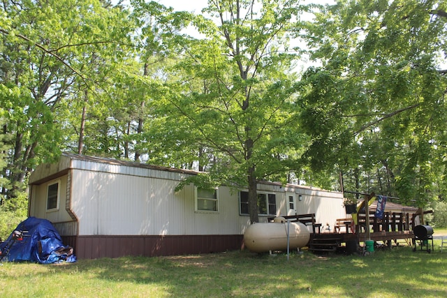 1864 Lenroy Valley Rd, Luzerne, MI 48636 - rear view of house featuring a deck and a yard