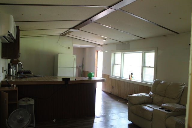 1864 Lenroy Valley Rd, Luzerne, MI 48636 - kitchen featuring freestanding refrigerator, a sink, wood finished floors, open floor plan, and a wainscoted wall