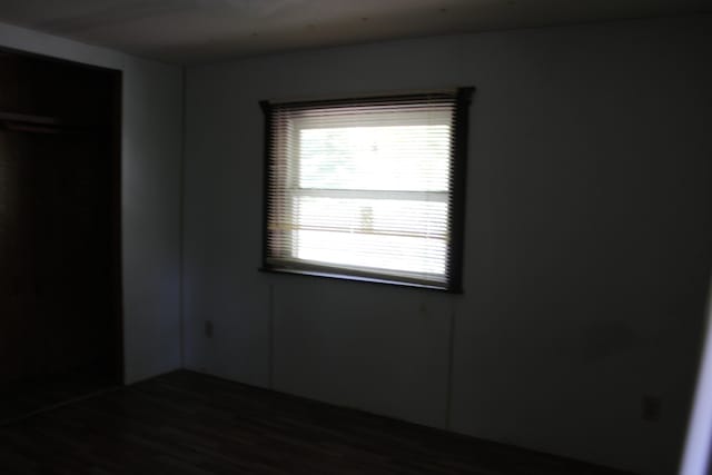 1864 Lenroy Valley Rd, Luzerne, MI 48636 - unfurnished bedroom with dark wood finished floors