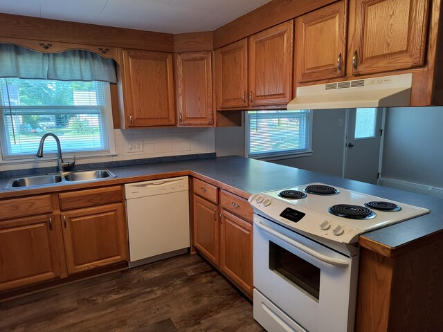 206 N Sixth St, Roscommon, MI 48653 - kitchen with white appliances, under cabinet range hood, a sink, and brown cabinets