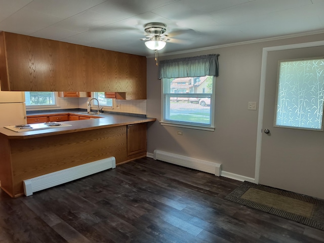 206 N Sixth St, Roscommon, MI 48653 - kitchen with a sink, a baseboard heating unit, a ceiling fan, white stovetop, and crown molding