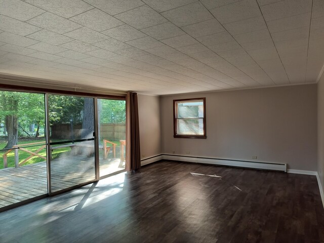 206 N Sixth St, Roscommon, MI 48653 - unfurnished room with baseboard heating, wood finished floors, ornamental molding, and baseboards