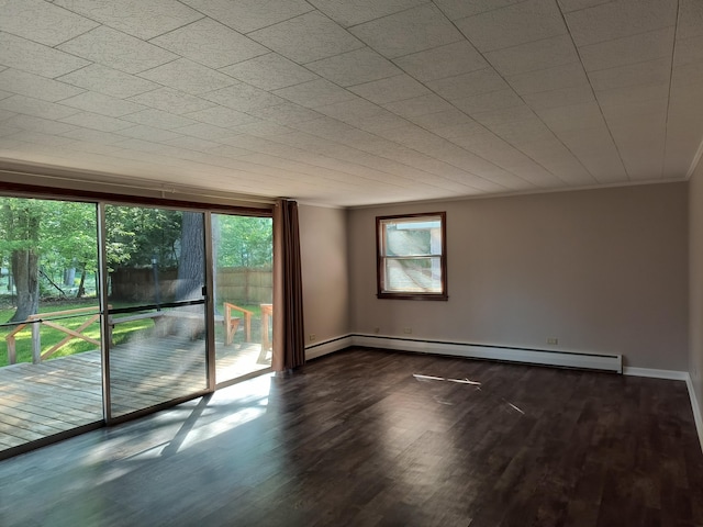 206 N Sixth St, Roscommon, MI 48653 - unfurnished room featuring baseboard heating, wood finished floors, ornamental molding, and baseboards