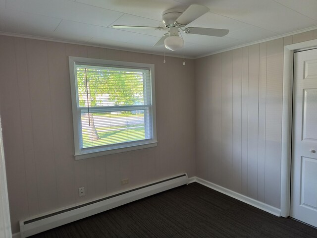 206 N Sixth St, Roscommon, MI 48653 - empty room featuring a baseboard radiator, ceiling fan, ornamental molding, and baseboards
