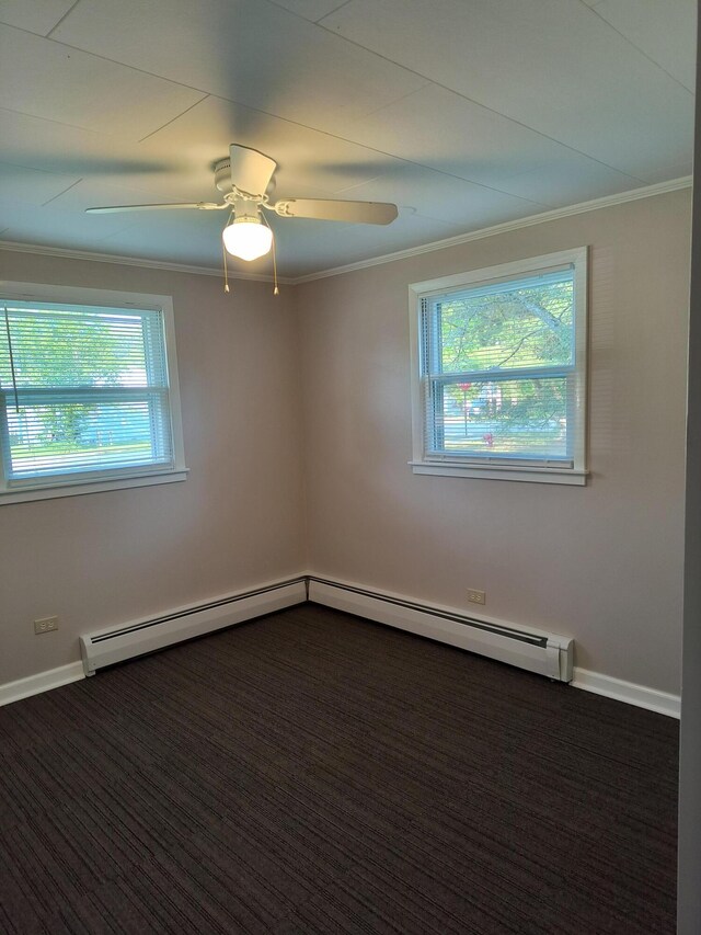 206 N Sixth St, Roscommon, MI 48653 - spare room featuring healthy amount of natural light, crown molding, dark colored carpet, a ceiling fan, and baseboards
