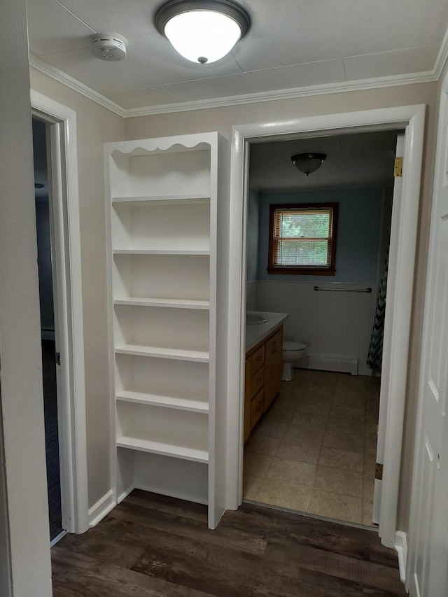 206 N Sixth St, Roscommon, MI 48653 - full bath featuring crown molding, vanity, wood finished floors, and toilet