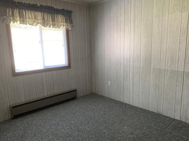 14501 3rd St, Hubbard Lake, MI 49747 - empty room with a baseboard heating unit and carpet floors