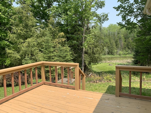14501 3rd St, Hubbard Lake, MI 49747 - wooden deck featuring a forest view