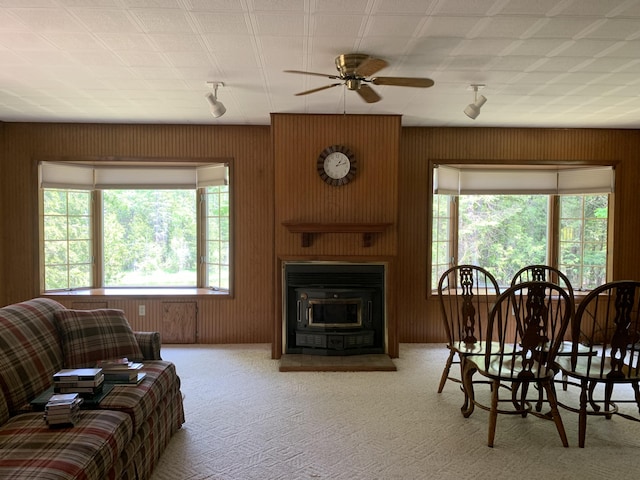 14501 3rd St, Hubbard Lake, MI 49747 - carpeted dining area with a ceiling fan and wood walls