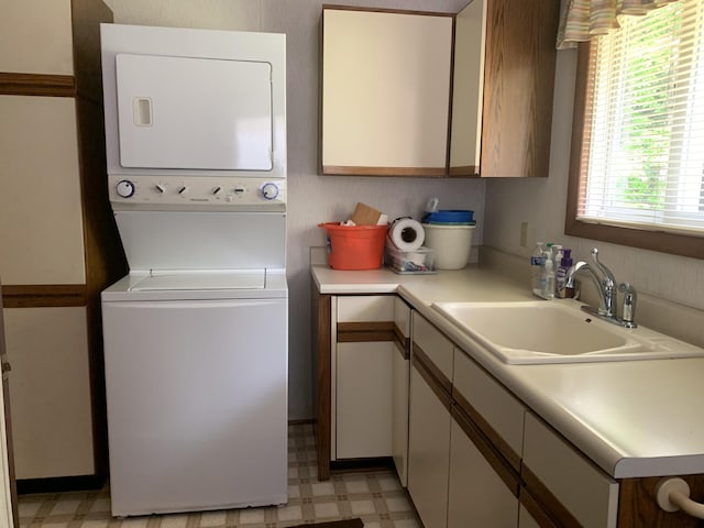 14501 3rd St, Hubbard Lake, MI 49747 - laundry room with stacked washer / drying machine and light floors