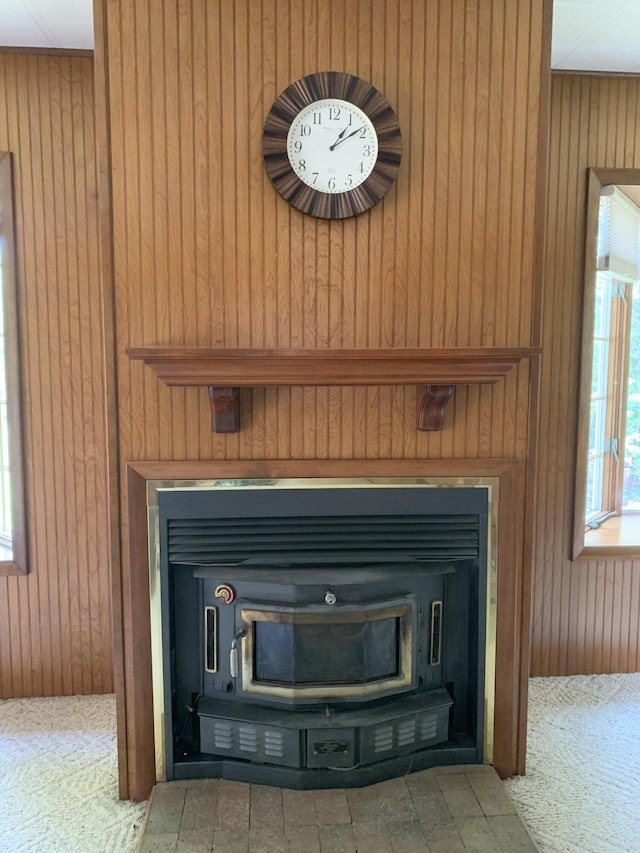 14501 3rd St, Hubbard Lake, MI 49747 - detailed view of wooden walls, a fireplace, and carpet