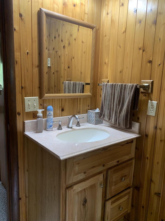 14501 3rd St, Hubbard Lake, MI 49747 - bathroom featuring vanity and wood walls