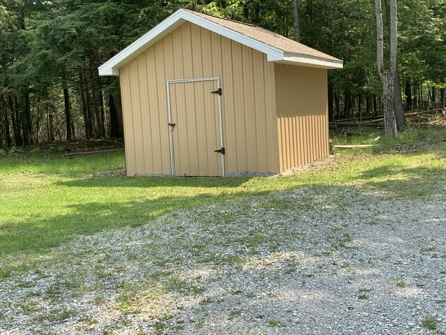 14501 3rd St, Hubbard Lake, MI 49747 - view of shed featuring a view of trees