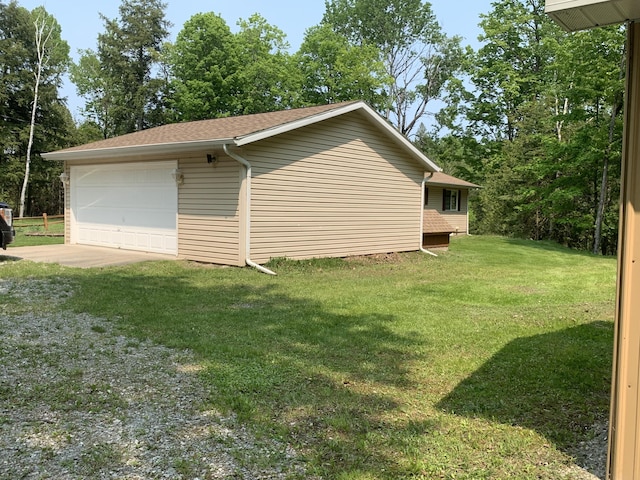14501 3rd St, Hubbard Lake, MI 49747 - view of side of home with a lawn and a shingled roof