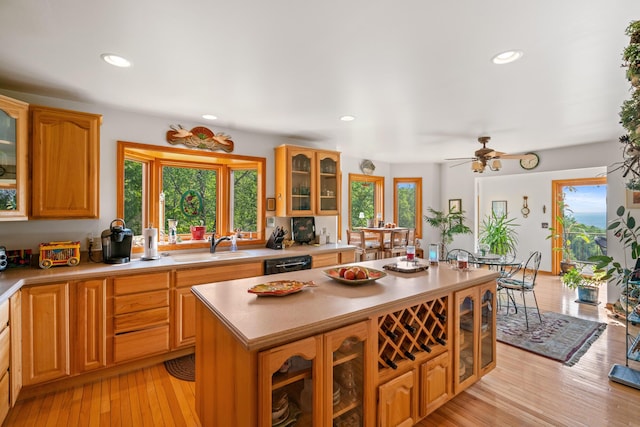10077 Royal Coachman Trl, Gaylord, MI 49735 - kitchen with healthy amount of natural light, light countertops, a sink, a kitchen island, and recessed lighting
