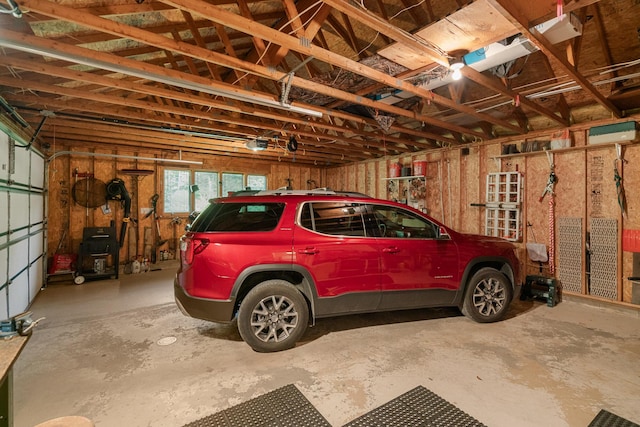 10077 Royal Coachman Trl, Gaylord, MI 49735 - garage featuring a garage door opener