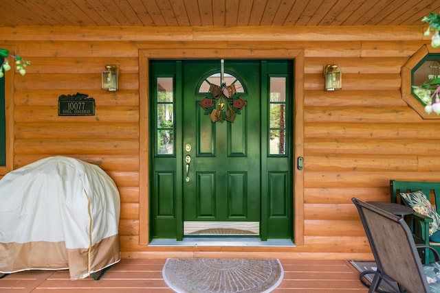 10077 Royal Coachman Trl, Gaylord, MI 49735 - view of exterior entry with covered porch and log veneer siding