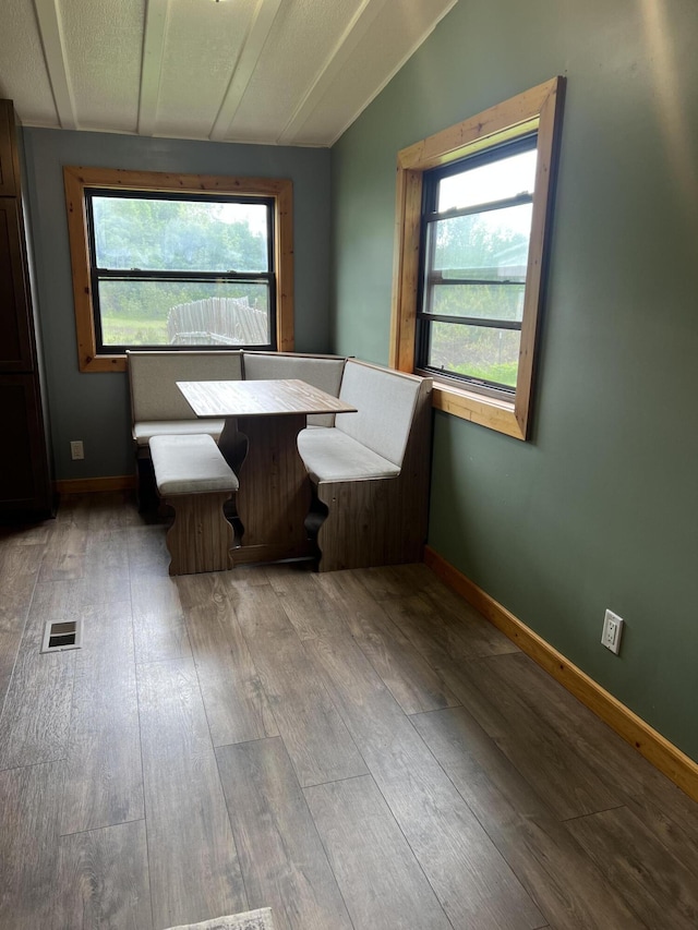 118 Westview Dr, Houghton Lake, MI 48629 - dining room featuring lofted ceiling, wood finished floors, healthy amount of natural light, and breakfast area