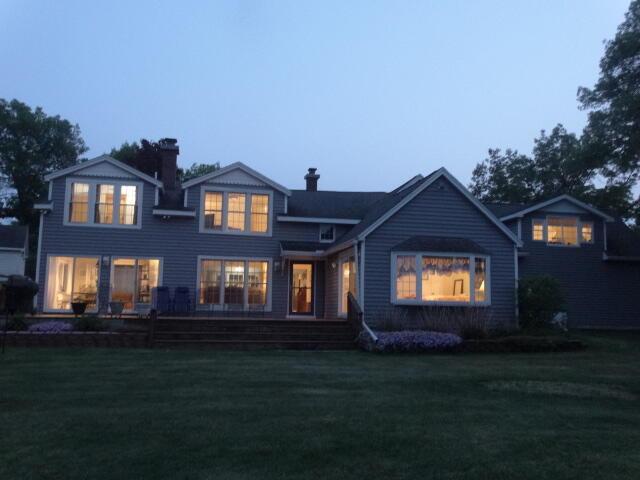 6168 F-41, Oscoda, MI 48750 - view of front facade with a front yard and a chimney