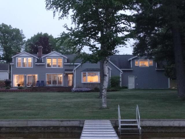 6168 F-41, Oscoda, MI 48750 - rear view of property featuring a yard
