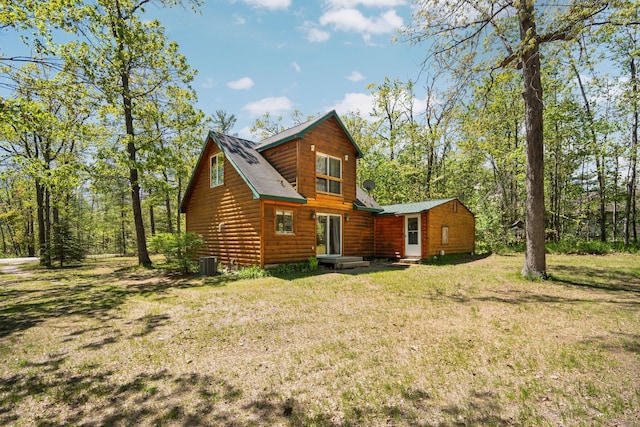 5466 Big Wolf Ln, Lewiston, MI 49756 - back of property with a yard, log veneer siding, and roof with shingles
