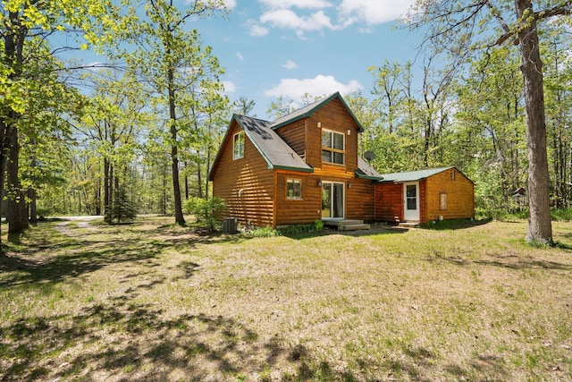 5466 Big Wolf Ln, Lewiston, MI 49756 - back of house featuring log veneer siding and a yard