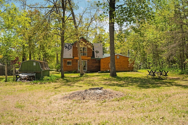 5466 Big Wolf Ln, Lewiston, MI 49756 - view of green lawn featuring a storage shed