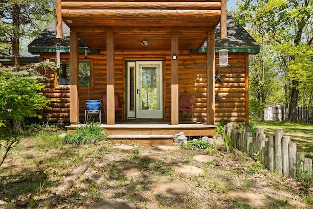 5466 Big Wolf Ln, Lewiston, MI 49756 - entrance to property with a porch and roof with shingles