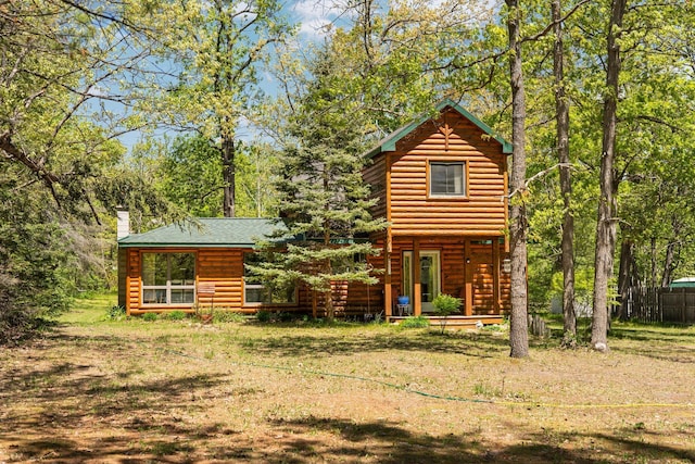 5466 Big Wolf Ln, Lewiston, MI 49756 - log-style house with a chimney and log veneer siding