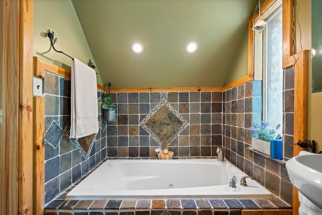 5466 Big Wolf Ln, Lewiston, MI 49756 - bathroom with a tub with jets, lofted ceiling, and recessed lighting